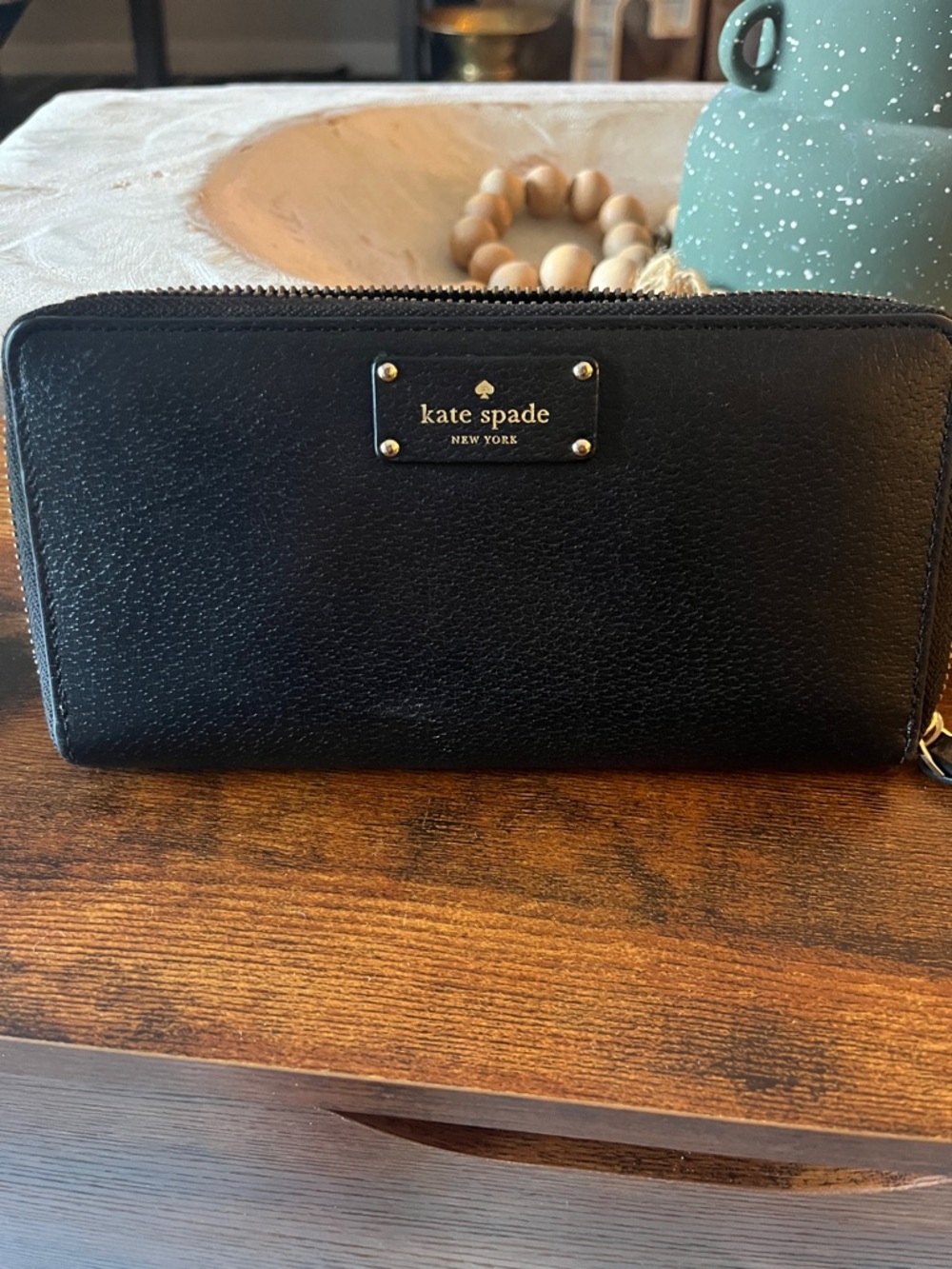 kate spade black zip-around leather wallet with gold logo plate